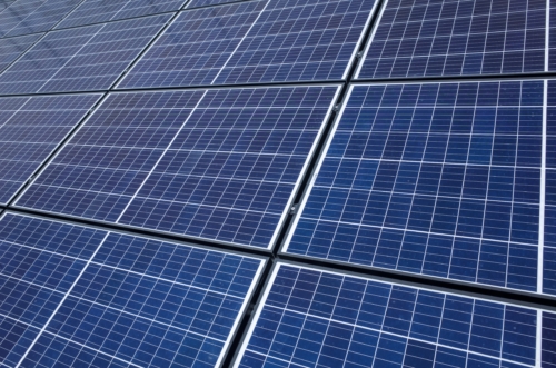 PV Solar panel roof, U.K. Industrial building clad in cells.